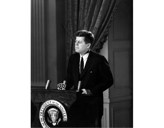 ST-45-3-61                                           13 March 1961  Reception for Latin American Diplomats, Officials, and Members of Congress. Medium close-up of President John F. Kennedy addressing the audience from podium; the President proposed the Alliance for Progress (Alianza para el Progreso), designed to promote economic cooperation between Latin American countries and the United States. East Room, White House, Washington, D.C.  Cecil Stoughton. White House Photographs. John F. Kennedy Presidential Library, Boston