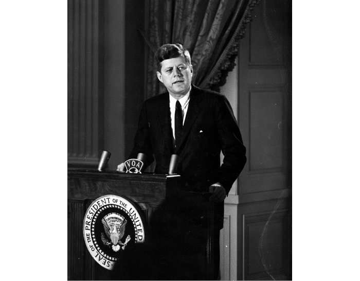 ST-45-6-61                                           13 March 1961  Reception for Latin American Diplomats, Officials, and Members of Congress. Medium close-up of President John F. Kennedy addressing the audience from podium; the President proposed the Alliance for Progress (Alianza para el Progreso), designed to promote economic cooperation between Latin American countries and the United States. East Room, White House, Washington, D.C.  Cecil Stoughton. White House Photographs. John F. Kennedy Presidential Library, Boston