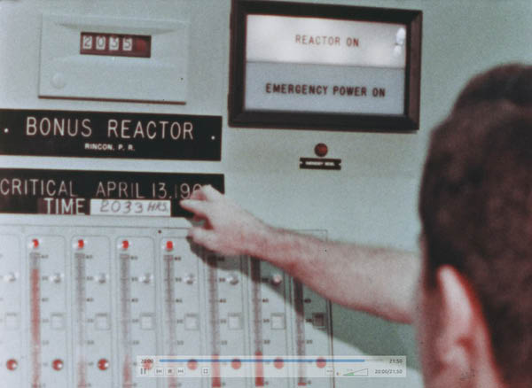 Control room view showing placard about BONUS going critical on April 13, 1964 at 2033 hours. the REACTOR ON sign is lit.