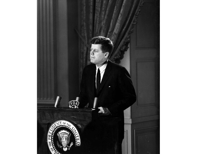 ST-45-3-61                                           13 March 1961  Reception for Latin American Diplomats, Officials, and Members of Congress. Medium close-up of President John F. Kennedy addressing the audience from podium; the President proposed the Alliance for Progress (Alianza para el Progreso), designed to promote economic cooperation between Latin American countries and the United States. East Room, White House, Washington, D.C.  Cecil Stoughton. White House Photographs. John F. Kennedy Presidential Library, Boston