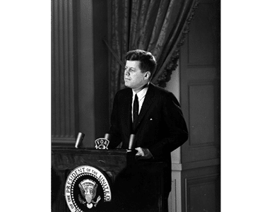 ST-45-3-61                                           13 March 1961  Reception for Latin American Diplomats, Officials, and Members of Congress. Medium close-up of President John F. Kennedy addressing the audience from podium; the President proposed the Alliance for Progress (Alianza para el Progreso), designed to promote economic cooperation between Latin American countries and the United States. East Room, White House, Washington, D.C.  Cecil Stoughton. White House Photographs. John F. Kennedy Presidential Library, Boston
