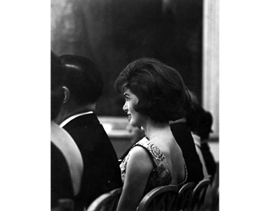 ST-45-5-61                                           13 March 1961  Reception for Latin American Diplomats, Officials, and Members of Congress. Profile shot of First Lady Jacqueline Kennedy sitting in the audience. East Room, White House, Washington, D.C.  Cecil Stoughton. White House Photographs. John F. Kennedy Presidential Library, Boston