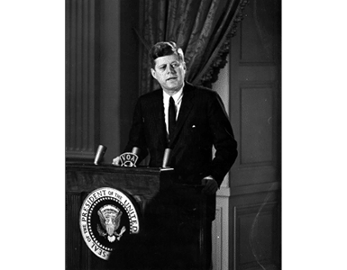 ST-45-6-61                                           13 March 1961  Reception for Latin American Diplomats, Officials, and Members of Congress. Medium close-up of President John F. Kennedy addressing the audience from podium; the President proposed the Alliance for Progress (Alianza para el Progreso), designed to promote economic cooperation between Latin American countries and the United States. East Room, White House, Washington, D.C.  Cecil Stoughton. White House Photographs. John F. Kennedy Presidential Library, Boston