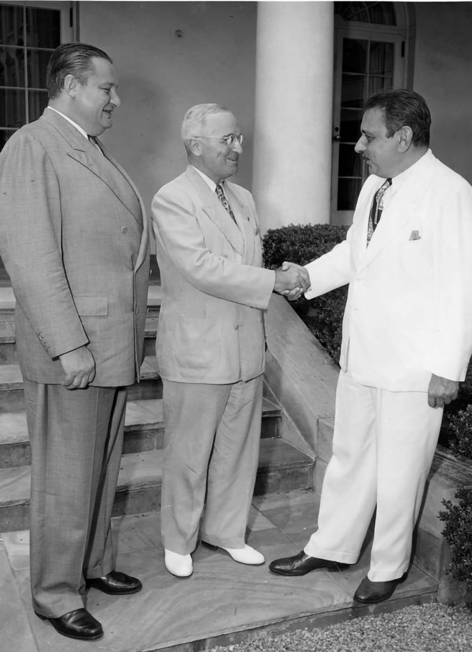 Photo of Puerto Rico's first elected Governor, Luis Munoz Marin (right), being greeted by President Harry S. Truman at the White House. On the left is Secretary of the Interior J.A. Krug. From: Beth Gore.