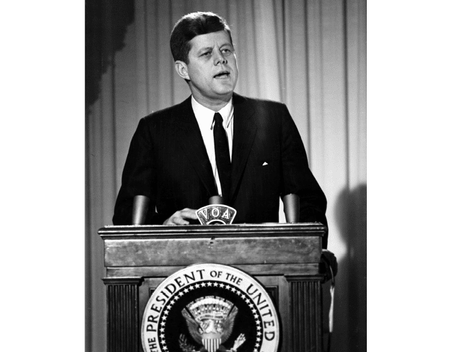 ST-45-4-61                                           13 March 1961  Reception for Latin American Diplomats, Officials, and Members of Congress. Medium close-up of President John F. Kennedy addressing the audience from podium; the President proposed the Alliance for Progress (Alianza para el Progreso), designed to promote economic cooperation between Latin American countries and the United States. East Room, White House, Washington, D.C.  Cecil Stoughton. White House Photographs. John F. Kennedy Presidential Library, Boston