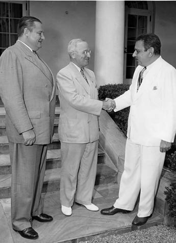 Photo of Puerto Rico's first elected Governor, Luis Munoz Marin (right), being greeted by President Harry S. Truman at the White House. On the left is Secretary of the Interior J.A. Krug. From: Beth Gore.