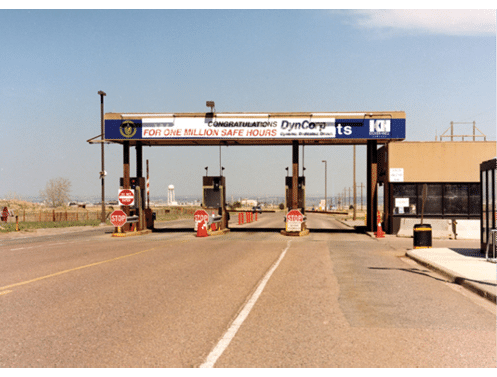 A road with a toll booth and a sign that says “For one million safe hours". AI generated content