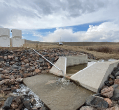 A concrete ramp leads to a water source, with a truck parked nearby. AI generated content