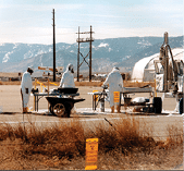 A group of people wearing protective gear are standing next to a truck. AI generated content