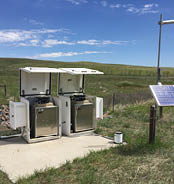 Two white appliances are sitting on a concrete slab in a grassy field. AI generated content