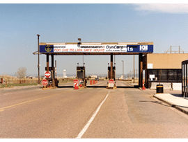 A road with a toll booth and a sign that says “For one million safe hours". AI generated content