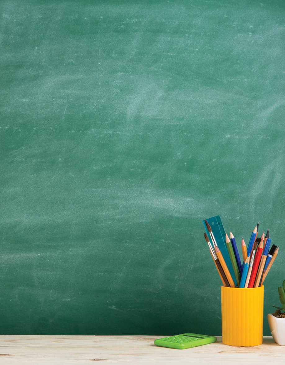 Education concept - school supplies on the desk in the auditorium
